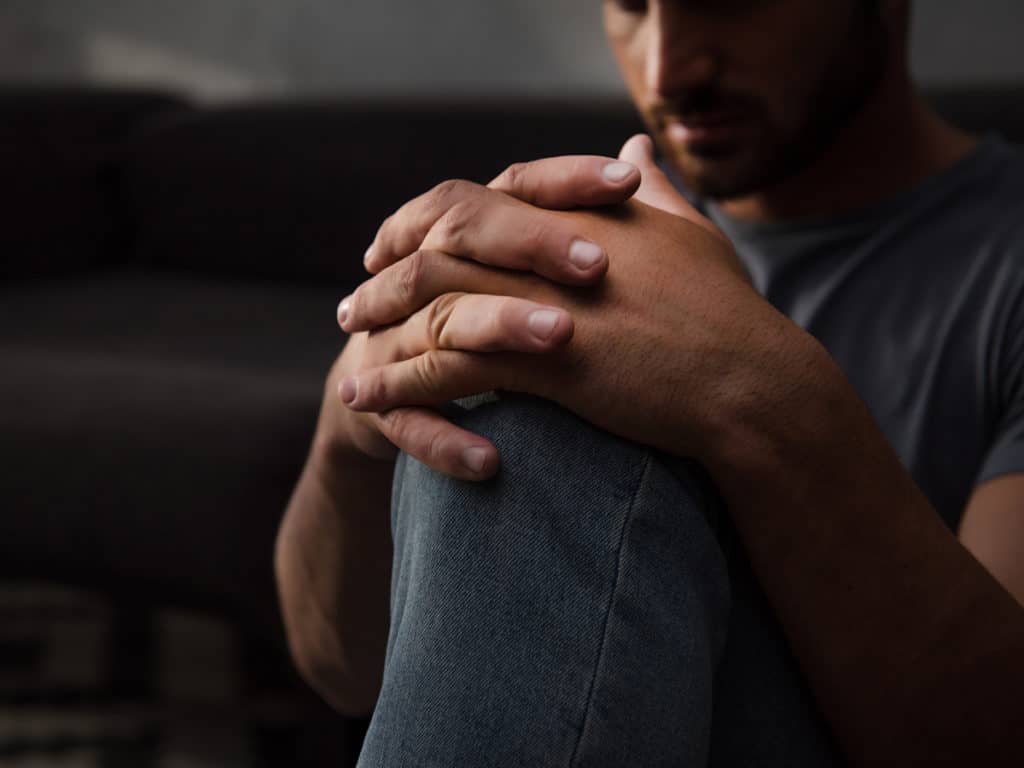 Stressed Man sitting on Floor Sexual Assualt Case