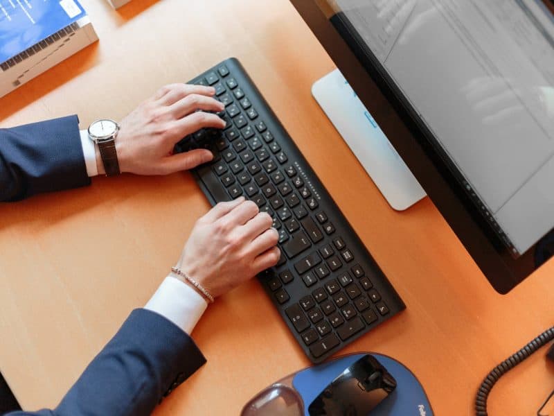 Man in suit typing pexels-photo